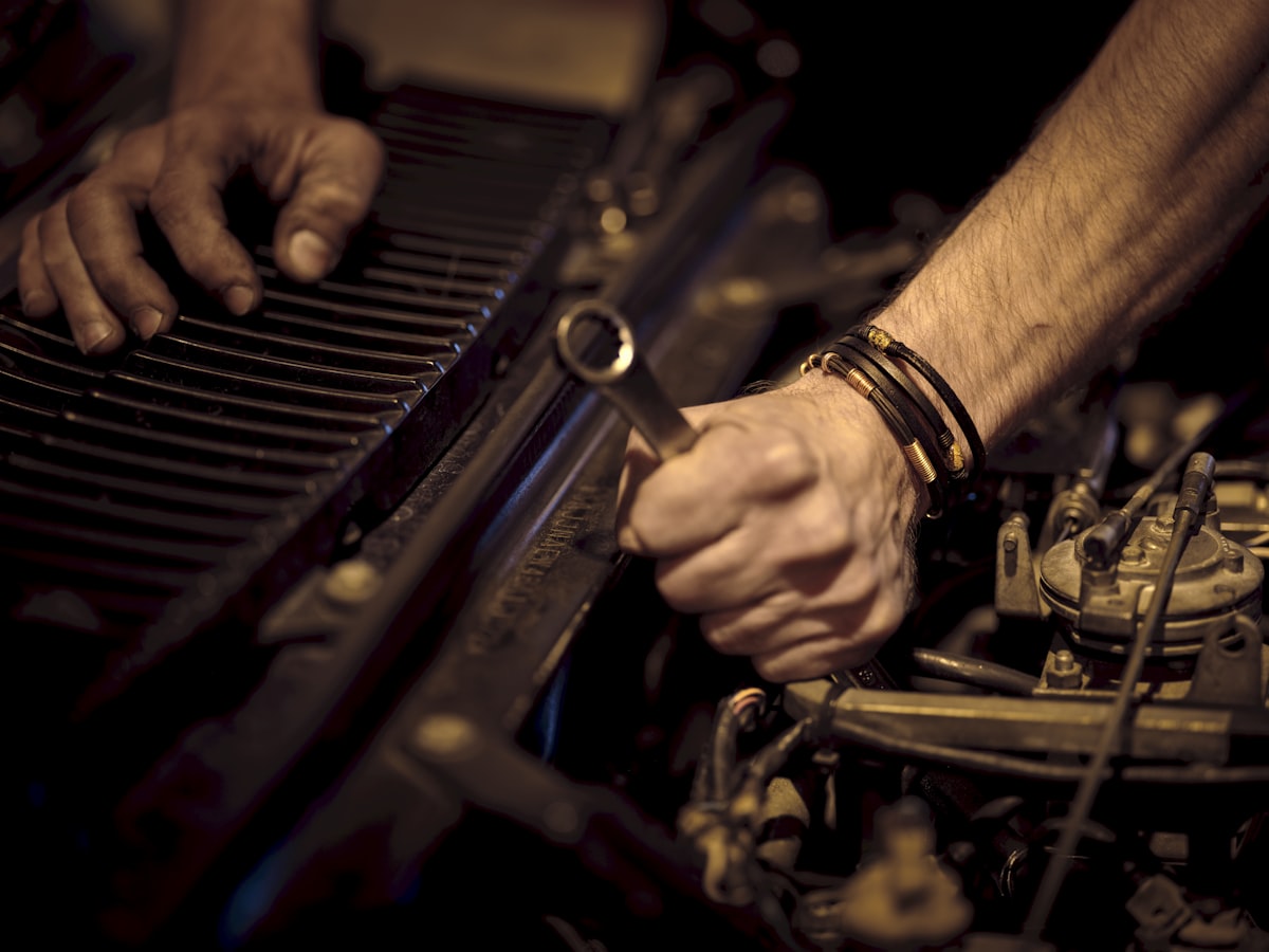 Qualified mechanic inspecting a modern car engine under the bonnet
